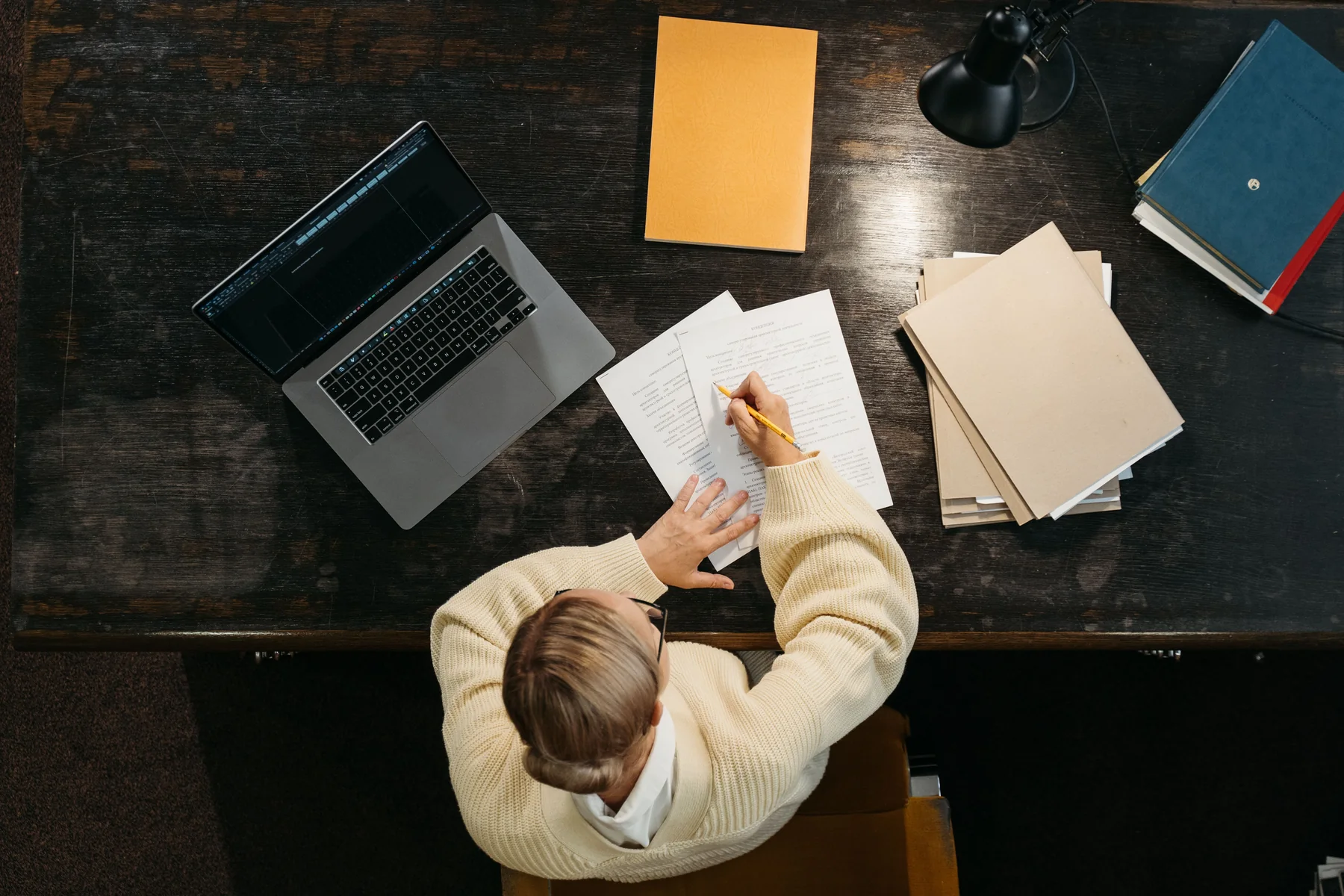 Desk with laptop, notebook and reference materials