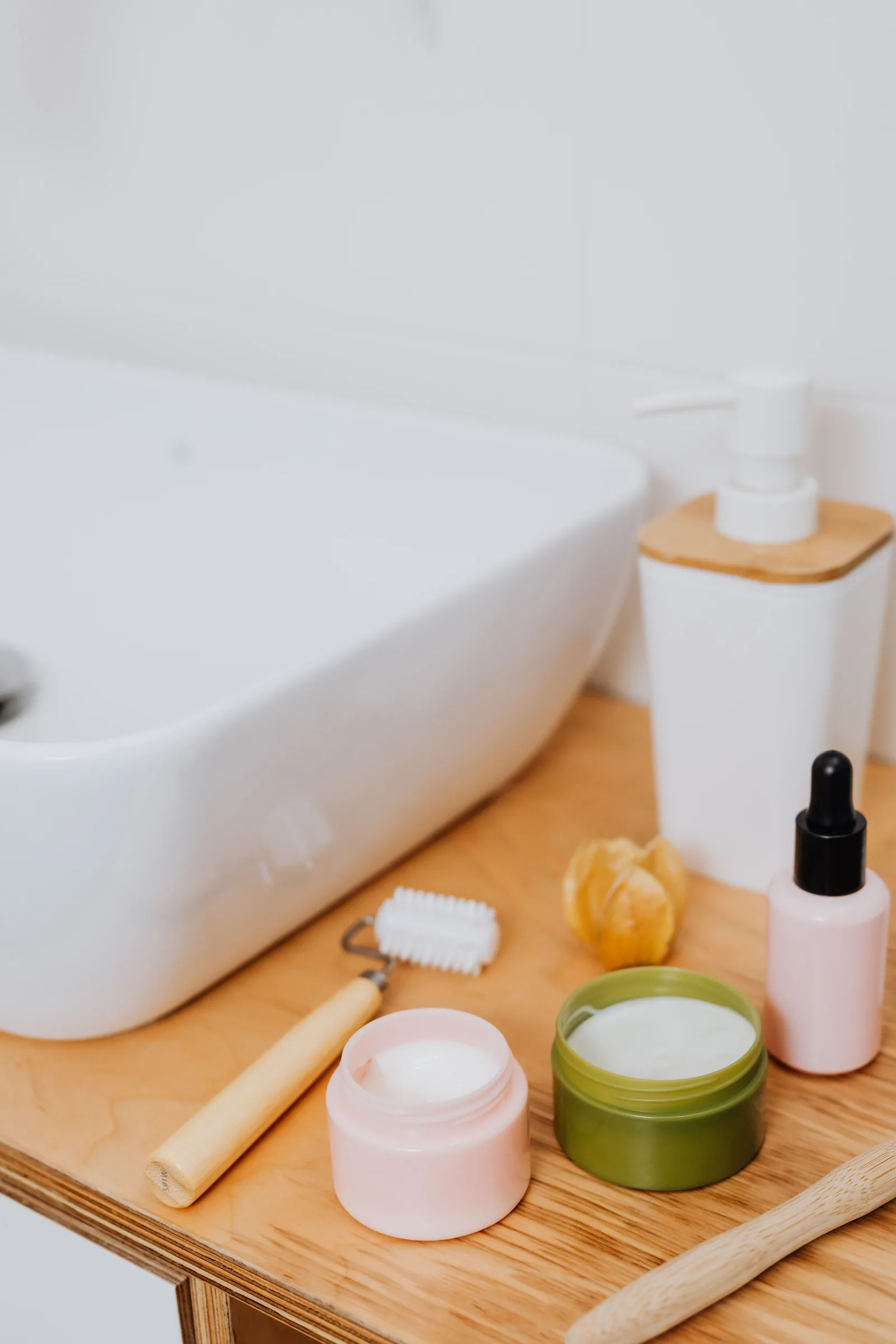 Skincare and personal-care products beside a bathroom sink